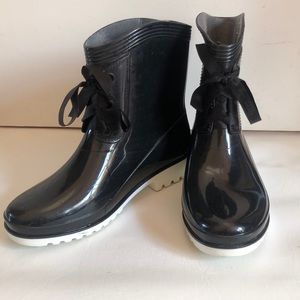 Slick black rain boots with cute ribbon detail